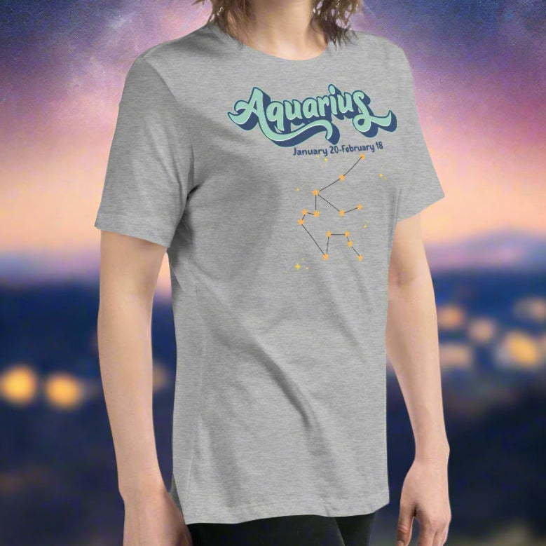 Woman in a heather grey astrology Aquarius T-shirt facing to the right side. You can see the short sleeves going midway down her upper arms. Side seam is visible. You can see the front of the shirt. Astrology Zodiac Aquarius Woman's Tee
