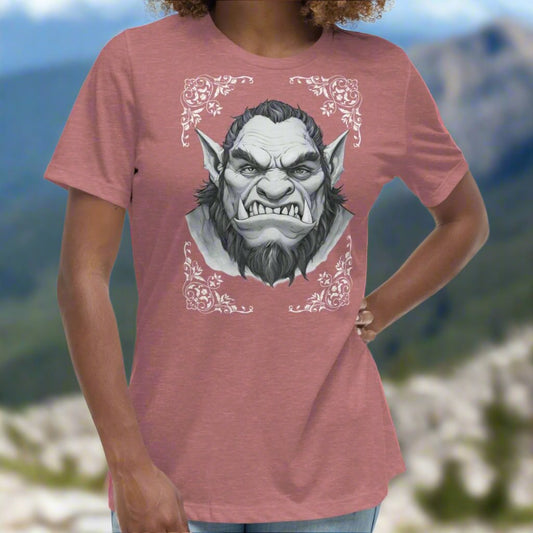 Orc Women's T-Shirt, heather mauve, front view. Flower corner borders in white frame a black and white image a fierce Orc. Bearded, tusk like teeth, and pointed ears of a deadly fae.