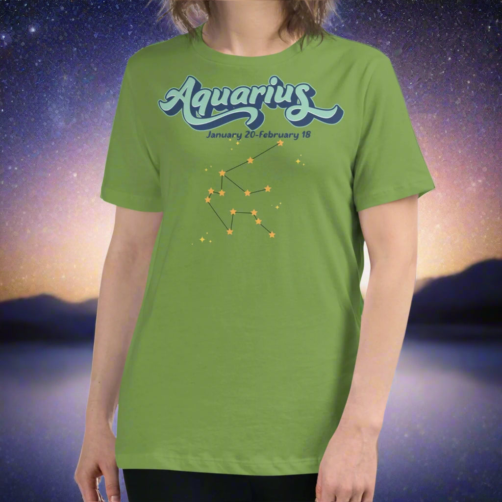 Woman in a leaf green astrology Aquarius T-shirt facing forward. At the top in light blue is the word Aquarius outlined in deeper blue. Below this it says January 20- February 18. Under this is the Aquarius constellation with orange yellow stars connected by a black line. Astrology Zodiac Aquarius Woman's Tee