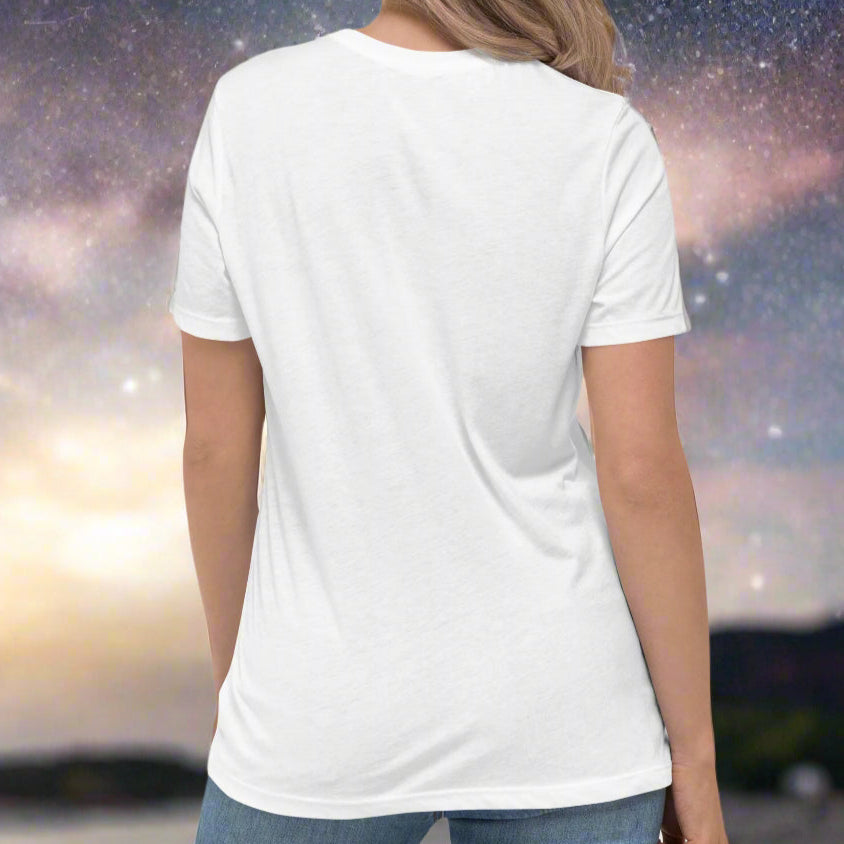 Woman wearing a white t-shirt turned to show the back. You can see the top of the crew neck collar. The sleeves end mid upper arm and are short sleeves. Aries constellation zodiac astrology sign.