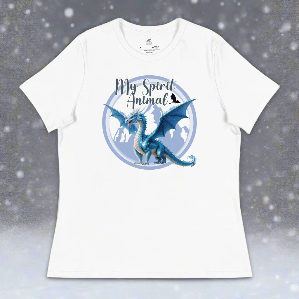 My Spirit Animal Dragon Women's Graphic Tee, front view of flat white shirt, Blue Ice Dragon with wings spread standing in front of snow capped mountain range with a dragon silhouette flying above within a blue grey circle