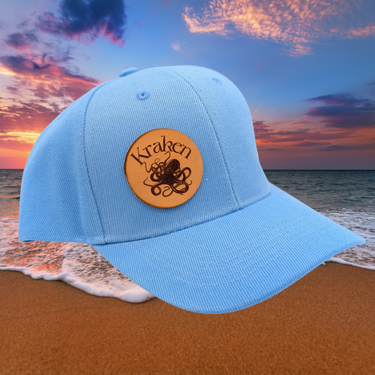 Front Right View Light Blue Hat. Laser Engraved Leather Patch Text Kraken curved above the image of a Kraken. Kraken Viking Hat 