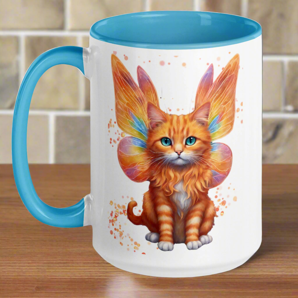 Ceramic Mug with blue interior and handle. Orange tabby striped Fairy Cat on both sides of Mug, Cat features orange wings with hints of blue and pink