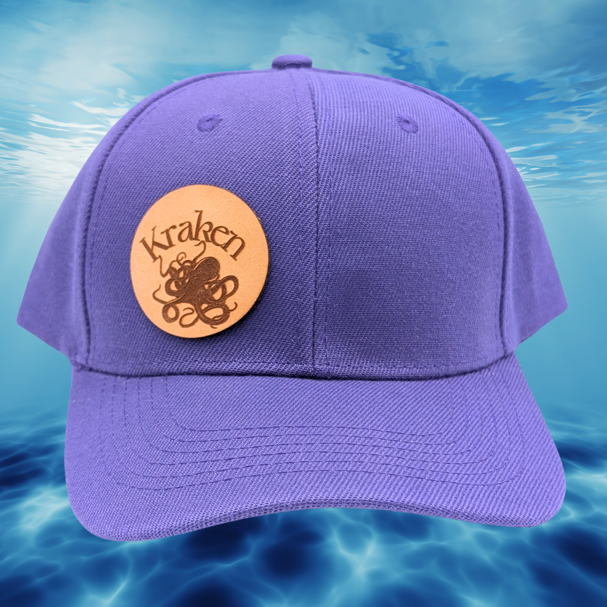 Front Right View purple Hat. Laser Engraved Leather Patch Text Kraken curved above the image of a Kraken. Kraken Viking Hat 