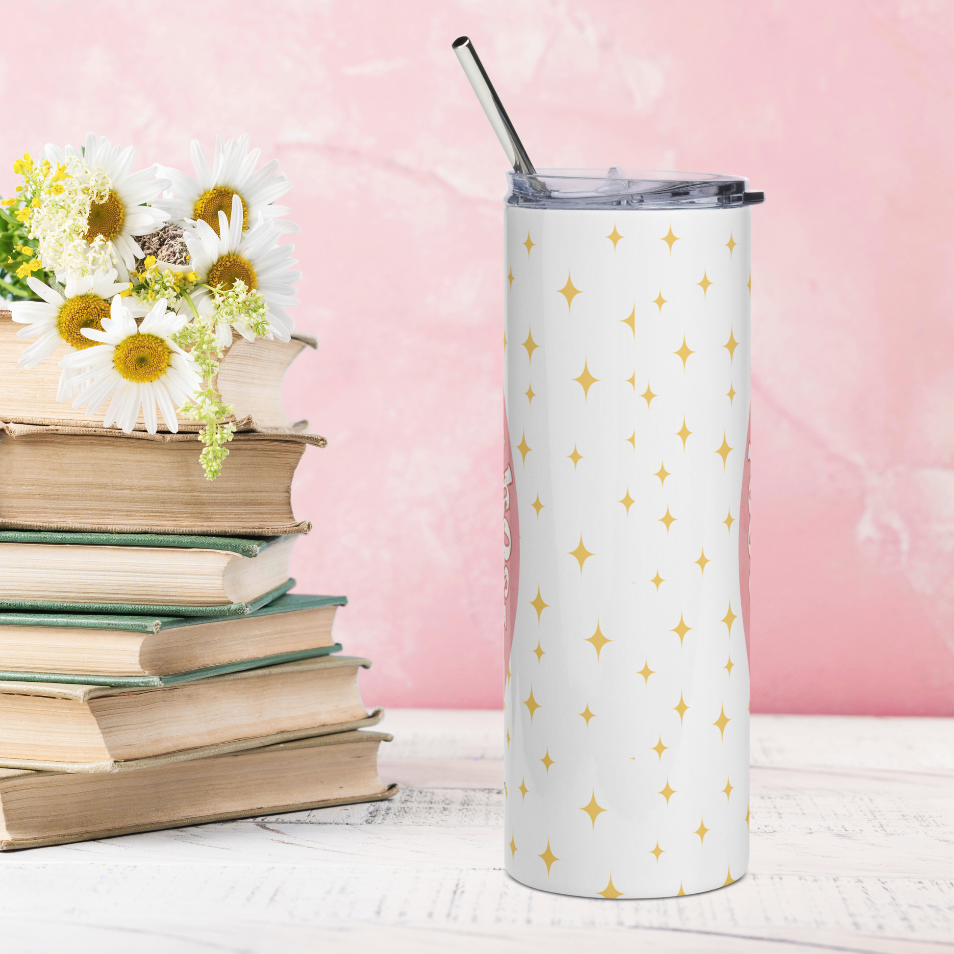 Back view of Pink Coquette Book Ghost Stainless Steel Tumbler on White Background. There are yellow stars in the background on the white. Lid is on the tumbler with the metal straw sticking up out of the top. Whimsical Ghost Reading Book
