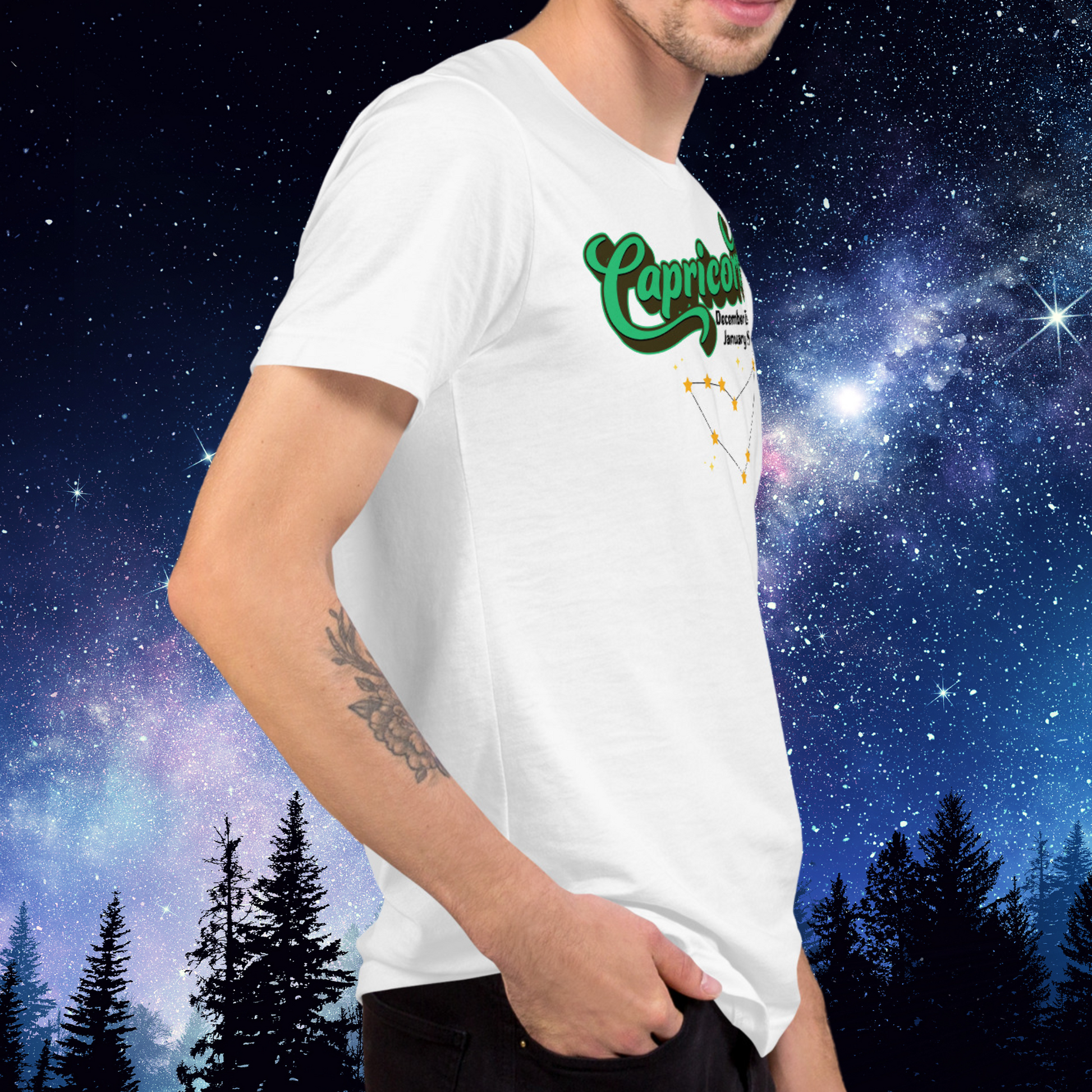 Right side view of model wearing white men's Capricorn Tee. You can see the side seam in the shirt. This astrology T-Shirt has the word Capricorn in large bright green script shadowed in deep brown almost black for a 3-D effect. Below this it Says December 22-January 19. Under Capricorn is the zodiac star constellation with yellow stars connected by a black line and lighter yellow smaller stars surrounding this. The perfect December or January Birthday Gift for him or yourself.