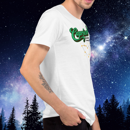 Right side view of model wearing white men's Capricorn Tee. You can see the side seam in the shirt. This astrology T-Shirt has the word Capricorn in large bright green script shadowed in deep brown almost black for a 3-D effect. Below this it Says December 22-January 19. Under Capricorn is the zodiac star constellation with yellow stars connected by a black line and lighter yellow smaller stars surrounding this. The perfect December or January Birthday Gift for him or yourself.