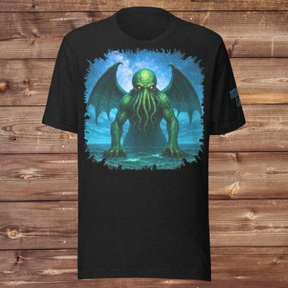 Cthulhu Black Heather Men's Graphic T-Shirt Flat View. Cthulhu Men's T-Shirt Front View on Model. Graphic upper half of shirt with night sky background. Cthulhu is emerging from the ocean. Wings spread from his back across the sky as he leans forward with tentacles hanging from his face toward the surface. He glows in green with radiant red eyes. 