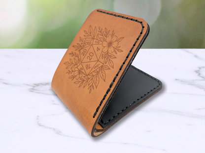 This is a view of the leather wallet laying flat on the marble surface. It is slightly open to give an idea of the  thickness of the leather that is sewn together. 