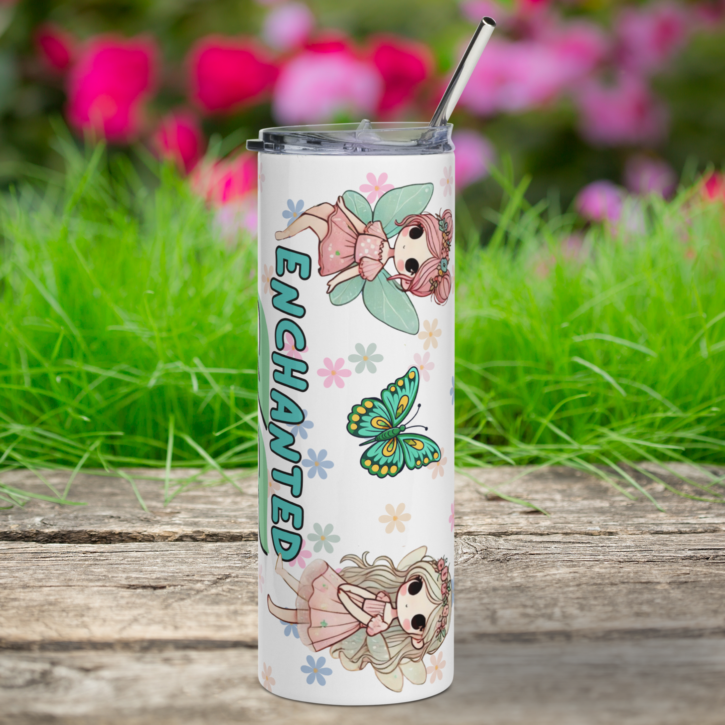 Fairy Enchanted AF Stainless Steel 20 Tumbler Mug right side view. You see a metal straw sticking up out of the tumbler and the edges of the lid. A fairy sits on the word enchanted with legs dangling over the E. She has pink hair in a double bun, a pink dress, and blue butterfly wings. Fairy 2 is standing by the D with long blonde hair, pink flowers in the hair, pink dress, and brown moth wings. Floral daisy background and a blue butterfly. Bookish Gift for Her