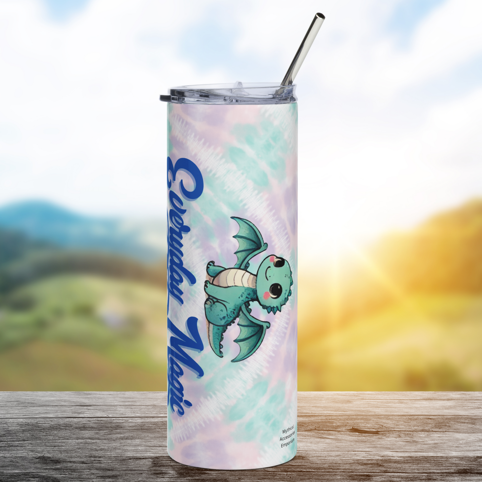 Everyday Magic Dragon Stainless Steel 20 oz Tumbler right side view. You see a sage green kawaii dragon sitting with wings spread. Below the dragon is the top of the text Everyday Magic. Background is green, pink, and purple tie dye. Book Lover's Club