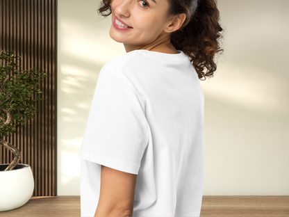 Woman wearing a white t-shirt. This is a back view from the left side. You can see the shoulder, short sleeve, and back of the crewneck collar and how it fits on the back. This is a regular fit shirt.