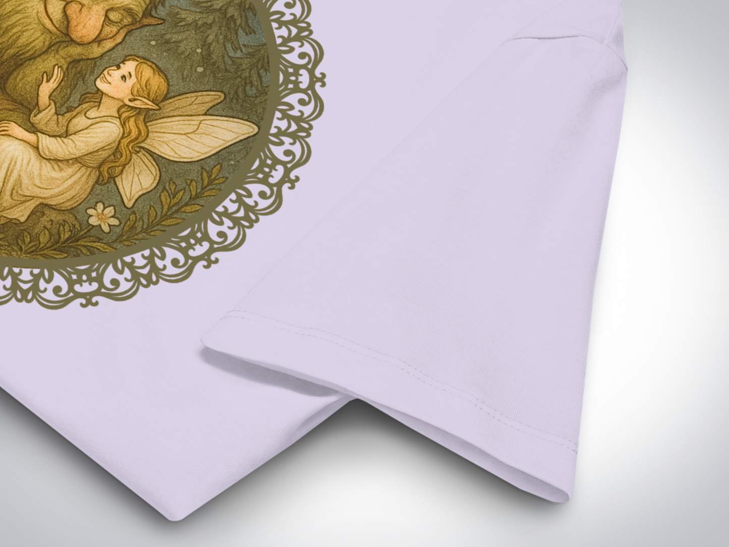 Lavender graphic tshirt close up of sleeve.  You can see the frame lattice around the graphic in an olive green, the forest background, the fairy placing her hand on the trolls arm is visible. 