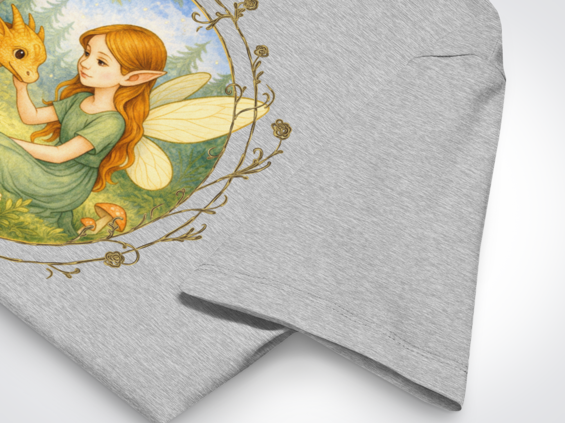 Athletic Grey Tshirt view of Dragon Fairy Fantasy Tee. Here you can see the upper shoulder of the shirt and where the sleeve is attached and the double need stitching on the hem of the sleeve. Part of the graphic is visible.