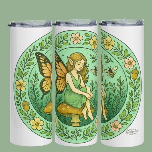 Fairy Circle Stainless Steel 20 oz Tumbler left, front, and right side view. In this photo you see the graphic from all three sides on a white tumbler. The graphic is a circle with  border of vines, flowers, and acorns. Inside the circle is a fairy with monarch style butterfly wings. She has large pointed ears and is wearing a sleeveless green dress. She is sitting on a red spotted mushroom. Inside the circle is a bee and additional vines. The background is a soft sage green for a vintage feel. 