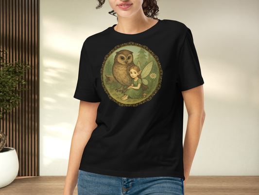 Person wearing a black t-shirt with an owl and fairy design.