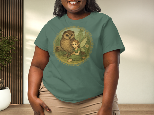 Person wearing a Bay Green Graphic t-shirt with an owl and fairy design. 