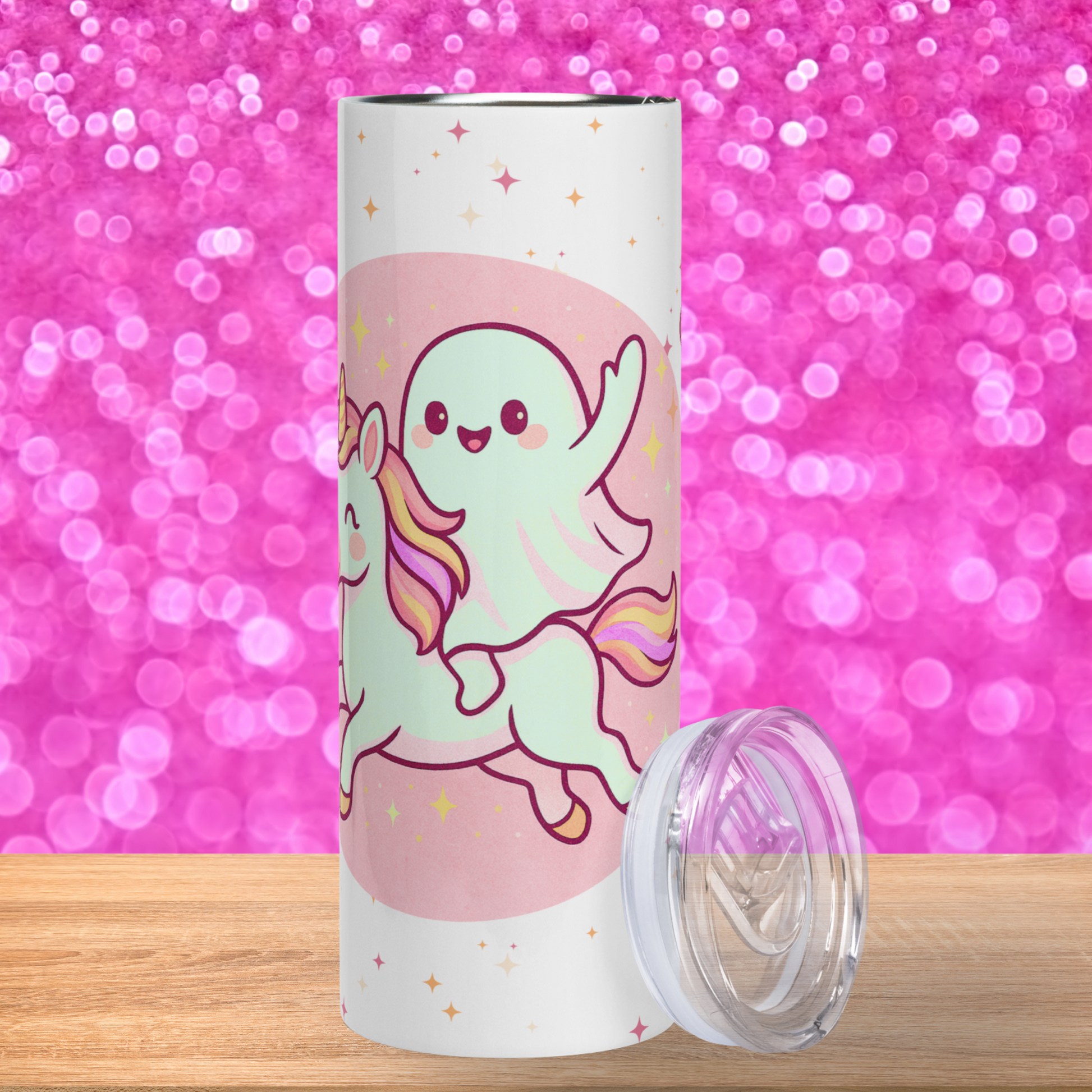 20 oz stainless steel tumbler front view. Here you see the pastel pink circle containing a unicorn with a rainbow mane and tail. Riding the unicorn with a hand in the hair is a kawaii cute ghost with rosy cheeks, a big smile, and large eyes. Pink Kawaii Coffee Tumbler