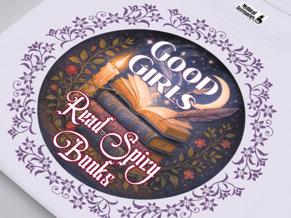 Up close view of graphic on a lavender women's tee. Graphic has a dark purple floral frame around the circle graphic. The graphic has a botanical feel surrounding a stack of magic books with the top book open with light emanating from the book. A candle is lit nearby and a starry sky with a crescent moon is above the books. Above the books it states "Good Girls" in white with a purple border. Below the books it states "Read Spicy Books" in white with a raspberry colored bordered