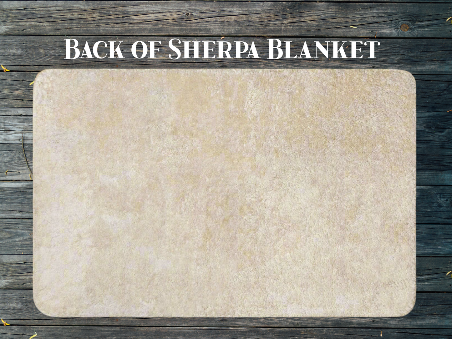 Back view of the Ice Dragon Lightweight Sherpa Throw Blanket. ON this side you see the natural or beige tone of the soft sherpa. Flat view of the blanket laying on a dark wood background. Above the blanket you see the text, "Back of Sherpa Blanket".