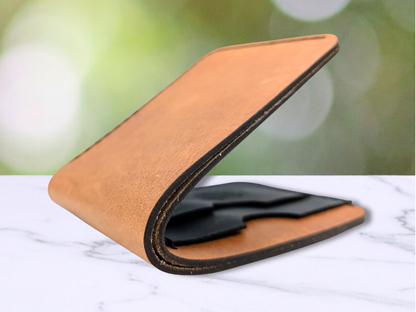 Here the wallet is slightly closed to give a better up close view of the edges of the laser cut veg tan leather that are darkened.