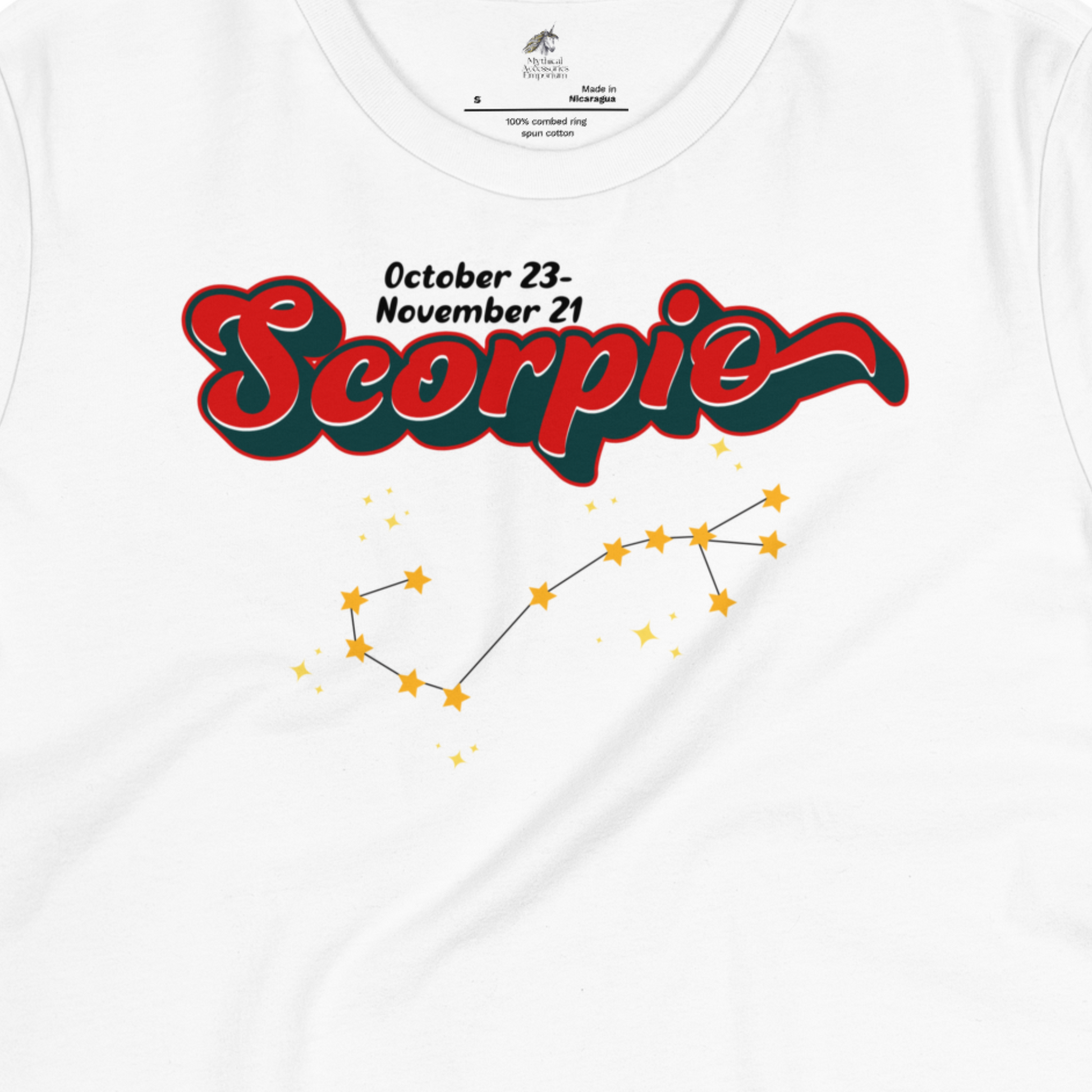 Up close front view of white zodiac women's Scorpio Tee. This astrology Scorpio T-Shirt has the word Scorpio in large red script shadowed in deep dark blue for a 3-D effect. Above this it Says October 23-November 21st. Under Scorpio is the zodiac star constellation with yellow stars connected by a black line and lighter yellow smaller stars surrounding this. The perfect October or November Birthday Gift for her or yourself.