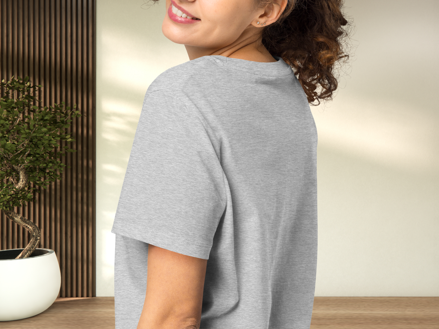 Model wearing a women's Romantasy Graphic Tee in Athletic Grey, left side view close up. The shoulder seam is visible, the back of the crewneck collar, and the sleeve comes to mid upper arm.