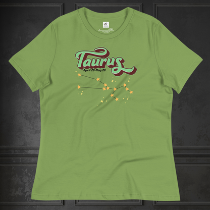 Front view of Leaf green Taurus Tee laying flat on a black surface. You can see the crew neck collar and short sleeves of the t shirt. This Astrology T-Shirt has the word Taurus in large leaf green script shadowed in deep brown for a 3-D effect. Below this it Says April 20-May 20. At the bottom is the star constellation for Taurus with yellow stars connected by a black line and  smaller stars surrounding the constellation. The perfect April or May Birthday Gift for Her or yourself.