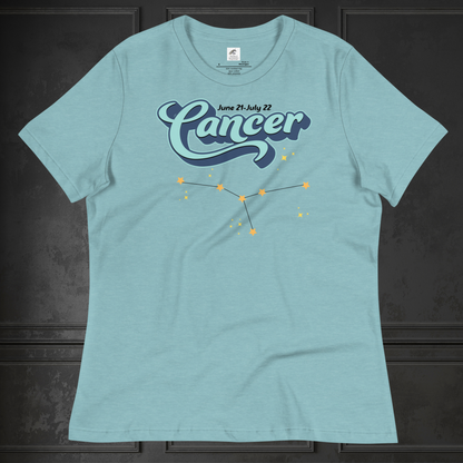 Front view of flat lay of heather blue lagoon women's Cancer Tee. This astrology Cancer T-Shirt has the word Cancer in large light blue script shadowed in deep blue for a 3-D effect. Above this it Says June 21-July 22. Under Cancer is the zodiac star constellation with yellow stars connected by a black line and lighter yellow smaller stars surrounding this. The perfect June or July Birthday Gift for Her or yourself.