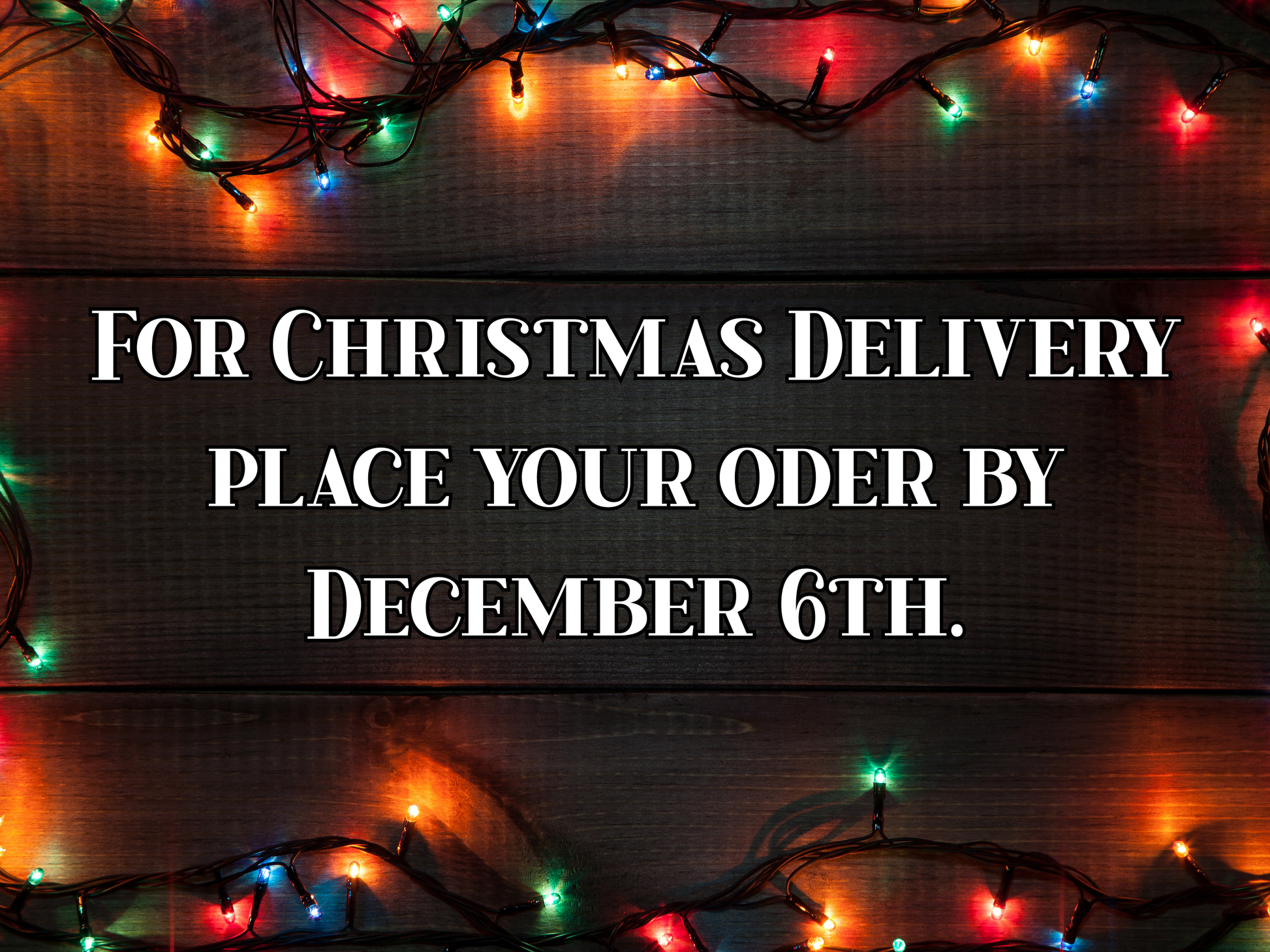 Christmas-themed text overlay with lights on a wooden background. For Christmas delivery place your order by December 6th