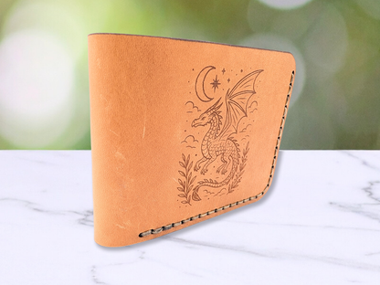 This is a view of the wallet standing on it's side. You are looking at the wallet from the folded leather side. You can see the dragon engraving on the bifold dad style wallet and the stitching of the handcrafted wallet is visible. Here you get an idea of the smooth feel of the leather and it's rich natural tones that vary. 