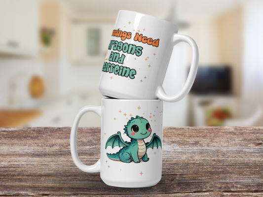 Dragon Ceramic Mug. Two mugs stacked on top of each other. Top mug with handle to the right says Mornings Need Dragon and Caffeine. Bot mug with handle to the left has kawaii chibi light green dragon surround by magic stars.