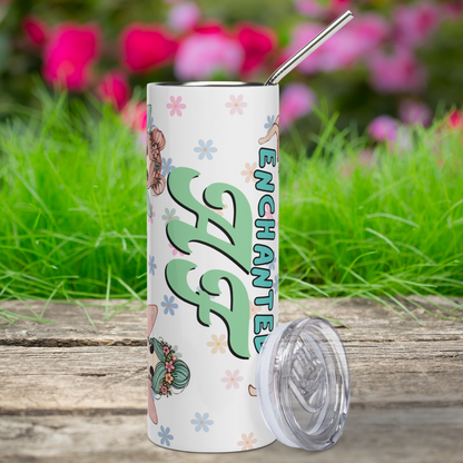 Enchanted AF Fairy 20 Stainless Steel Travel Tumbler Front View. Plastic BPA free lid is leaning against the right side. You see the word Enchanted in egg shell blue in print. Below this in calligraphy style is AF. You see a daisy floral background and to the left you see the tops of the hair of two fairies. Book Club Merch