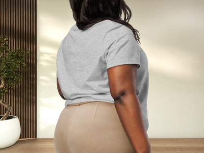 Curvy model wearing an athletic grey tshirt. Back view. Shirt is shown tucked in to khaki pants. You can see the length of the short sleeves are at mid point of the upper arm. Semi loose fit of the tshirt can be seen