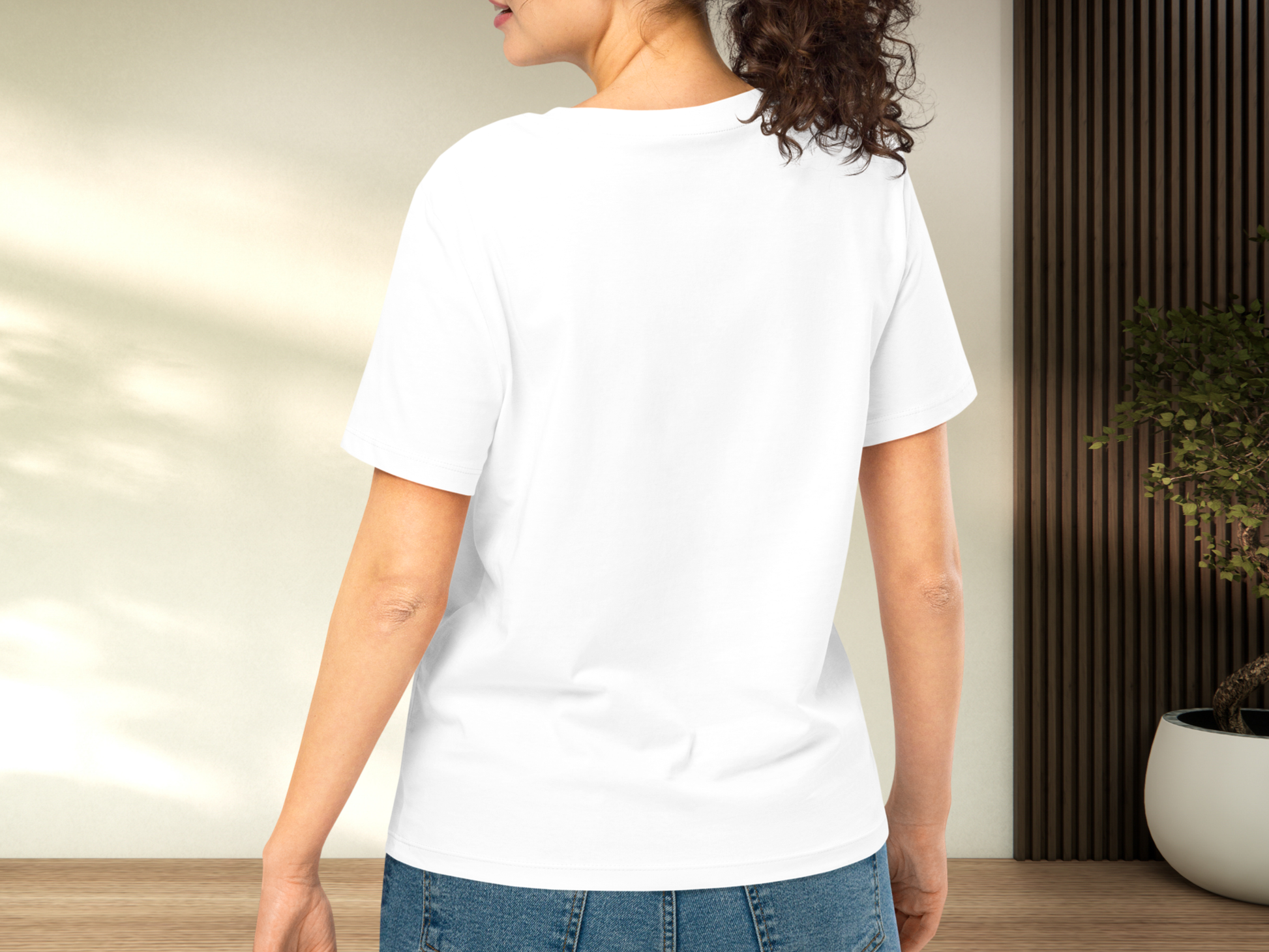 Back view of white shirt on model. Here you can see the back of the collar. the short sleeve stops at mid point of the upper arm. Hem stops at mid point of the hips. Shirt has a regular fit.