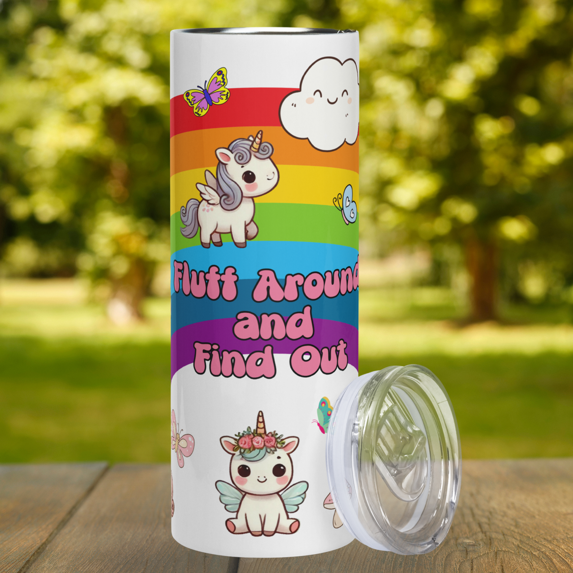 Fluff Around Find Out 20 oz Stainless Steel Tumbler front view. BPA free plastic lid leans against the right side. Middle of the rainbow with a smiling cloud at the top. In pink bubblegum color text, "Fluff Around and Find Out". Above the text is a Pegasus with a horn walking on the rainbow. Blue hair and mane. Below the text is a kawaii unicorn pegasus with blue hair and wings sitting with pink flowers around the horn. Bright butterflies in the background. Fantasy Funny Gift for Her