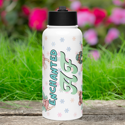 Enchanted AF Fairy Tumbler Front View with Black Lid. Enchanted is in blue text with a black outline. AF is a light pistachio green with black drop shadow. You can see the tops and bottoms of fairies to the left and right. Background is pastel daisies.