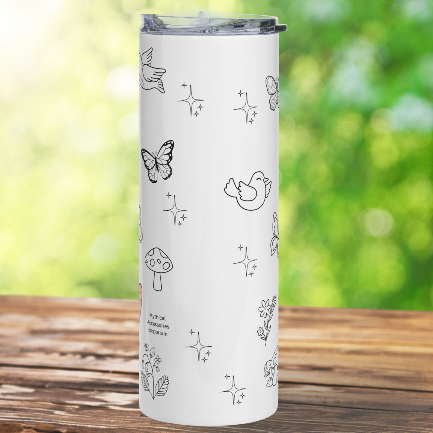 Kidnapped by Fairies 20 oz Stainless Steel Tumbler back view. You see the white tumbler with black and white doodles of butterflies, birds, mushrooms, flowers, and the strawberry plant. Kawaii Coffee Tumbler