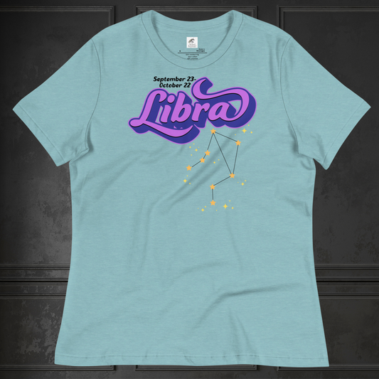 Front view of flat heather blue lagoon women's Libra Tee. This astrology Libra T-Shirt has the word Libra in large purple script shadowed in deep blue for a 3-D effect. Below this it Says September 23-October 22. Under Libra is the zodiac star constellation with yellow stars connected by a black line and lighter yellow smaller stars surrounding this. The perfect October or September Birthday Gift for Her or yourself.
