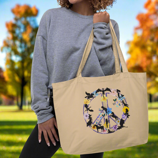 model holding natural organic tote fantasy peace sign, purple peace sign filled with mythological creatures dragon mermaid fairy unicorn witch pegasus