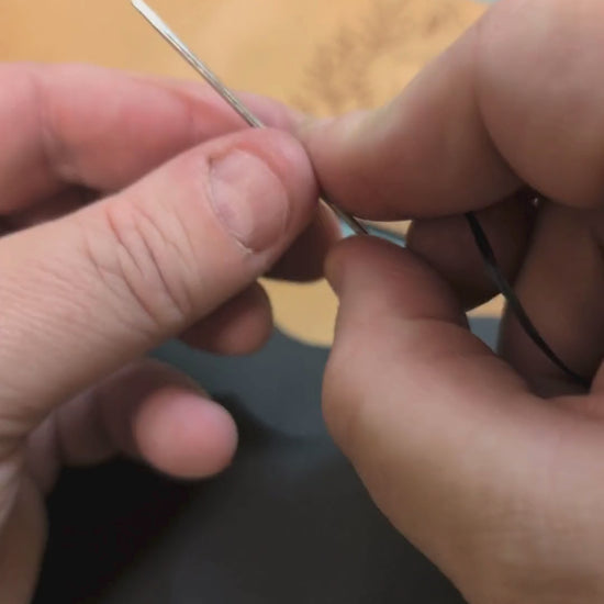 Video of the veg tan leather bi fold wallet being hand stitched together to form the cash compartment and to attach the card pockets. 