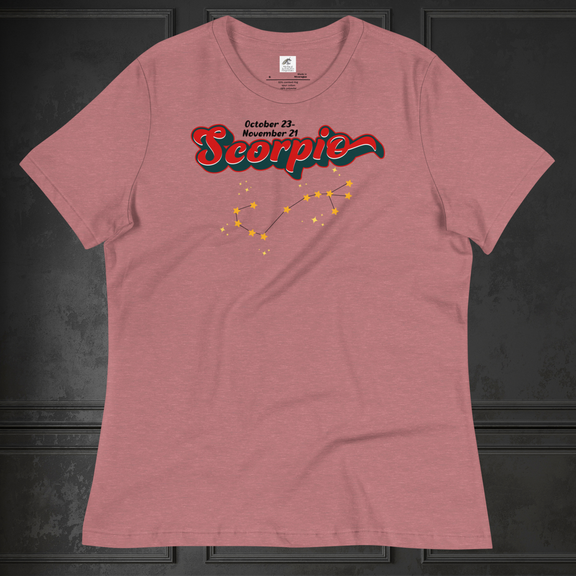 Front view of flat heather red women's Scorpio Tee. This astrology Scorpio T-Shirt has the word Scorpio in large red script shadowed in deep dark blue for a 3-D effect. Above this it Says October 23-November 21st. Under Scorpio is the zodiac star constellation with yellow stars connected by a black line and lighter yellow smaller stars surrounding this. The perfect October or November Birthday Gift for her or yourself.
