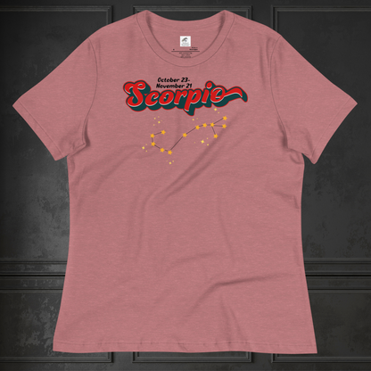 Front view of flat heather red women's Scorpio Tee. This astrology Scorpio T-Shirt has the word Scorpio in large red script shadowed in deep dark blue for a 3-D effect. Above this it Says October 23-November 21st. Under Scorpio is the zodiac star constellation with yellow stars connected by a black line and lighter yellow smaller stars surrounding this. The perfect October or November Birthday Gift for her or yourself.