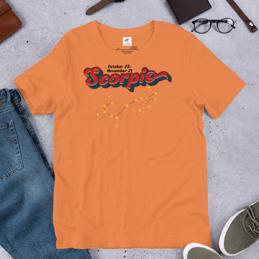 Front view of flat burnt orange men's Scorpio Tee. This astrology T-Shirt has the word Scorpio in large red script shadowed in black for a 3-D effect. Above  this it says October 23-November 21. Under Scorpio is the zodiac star constellation with yellow stars connected by a black line and lighter yellow smaller stars surrounding this. The perfect October or November Birthday Gift for him or yourself.