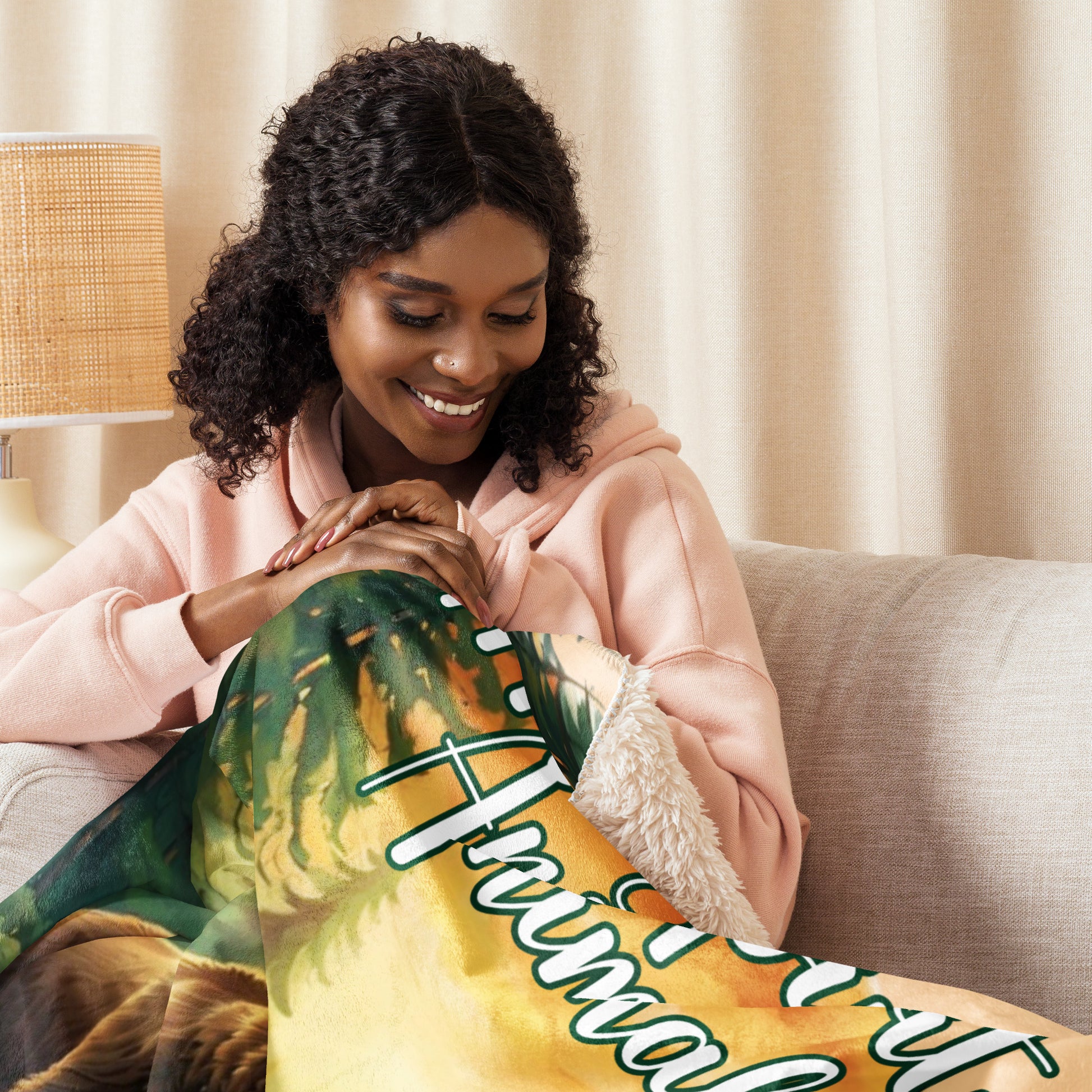 My Spirit Animal bear sherpa blanket.  Women in pajamas cuddled up with blanket. Grizzly Bear paused in front of logs walking through the forest framed in a sunset. My Spirit Animal text at the top in white script.