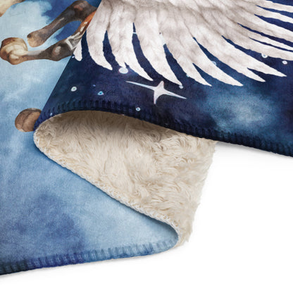 My Spirit Animal Pegasus Sherpa blanket. Up close view to see the soft top side and back of natural colored sherpa. Pegasus white feathered wings on a Pinto with a dark brown mane and tail, galloping through the sky against a background of clouds and stars. Mythical Accessories