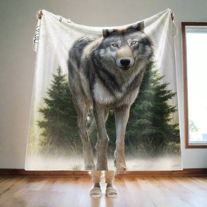 Wolf Women's Sherpa BLanket My Spirit Animal. Front view of wolf blanket held up in the arm by model. The 60"x80" blanket is folded 1/4 of the way over the models hands. Twin 
  bed size or as a queen bed throw. A grey timberwolf gazes at you from the forest. Timber Wolf Shamanic Totem Animal, Mythical Accessories Emporium.