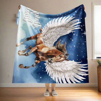 My Spirit Animal Pegasus Sherpa blanket. Women holding blanket up over her head. Blanket is folded down over her hands about 1/4, bottom of blanket almost comes to her ankles. BLanket size 60x80, Twin size blanket or perfect as a queen bed throw. Pegasus white feathered wings on a Pinto with a dark brown mane and tail, galloping through the sky against a background of clouds and stars. Mythical Accessories