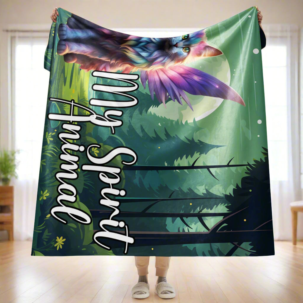 My Spirit Animal Fairy Cat sherpa blanket. Front view held up by a model, size 60x80, blanket folded about 1/4 over her hands held above her head, blankets drops to right above her ankles. Rainbow Fae Persian Cat wings spread behind her, tail curling to the right. Framed  in golden magic symbols. My Spirit Animal under the fairy cat in blue outlined in dark grey.