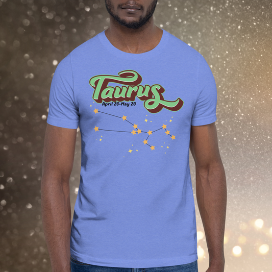 Front view of model wearing  heather Columbia blue men's Taurus Tee. This Astrology T-Shirt has the word Taurus in large leaf green script shadowed in deep brown for a 3-D effect. Below this it Says April 20-May 20. At the bottom is the star constellation for Taurus with yellow stars connected by a black line and  smaller stars surrounding the constellation. The perfect April or May Birthday Gift for him or yourself.